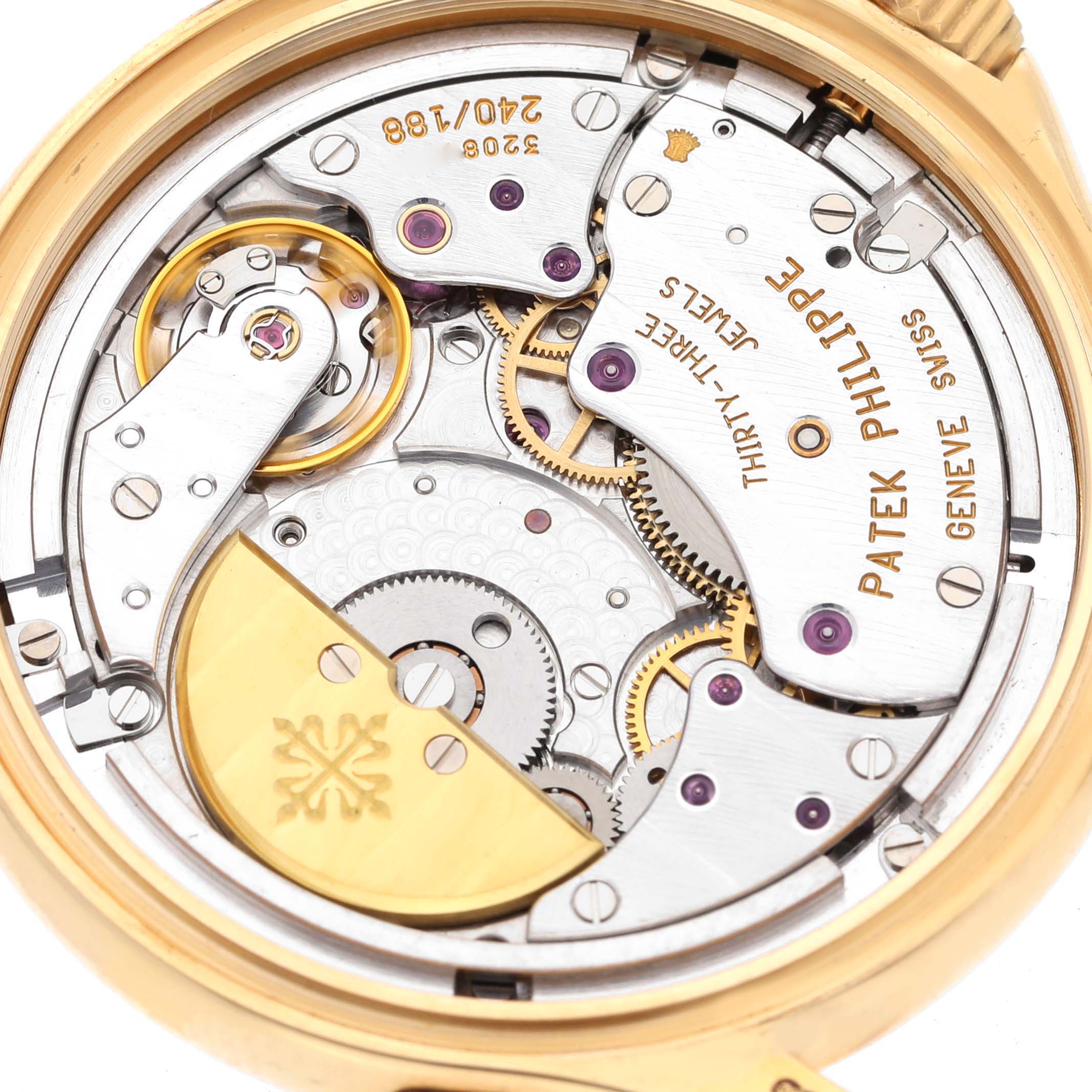 The image shows the back view of the Patek Philippe Complications 5110J Men's Yellow Gold Silver Dial 5110J Men's Yellow Gold Silver Dial model, revealing its intricate mechanical movement.