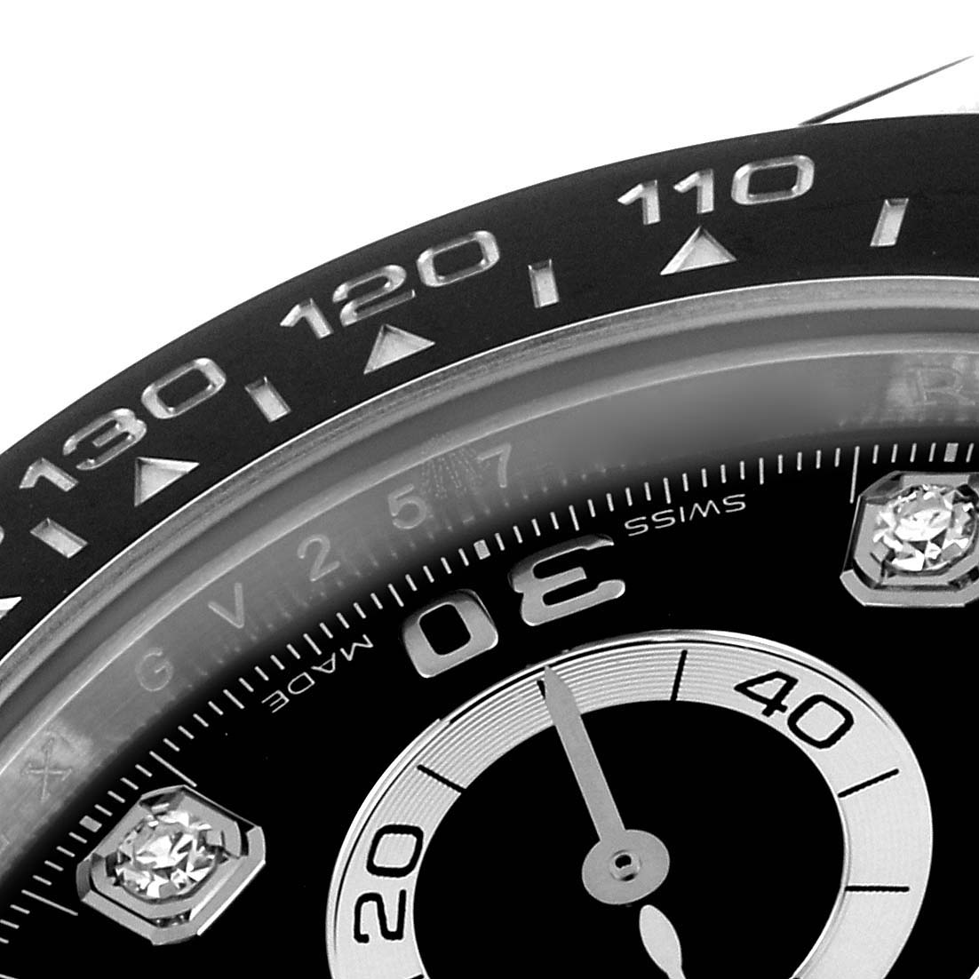 The image shows a close-up of the bezel and part of the dial of a Rolex Daytona 116519 Men's White Gold Black Dial 116519 Men's White Gold Black Dial watch.