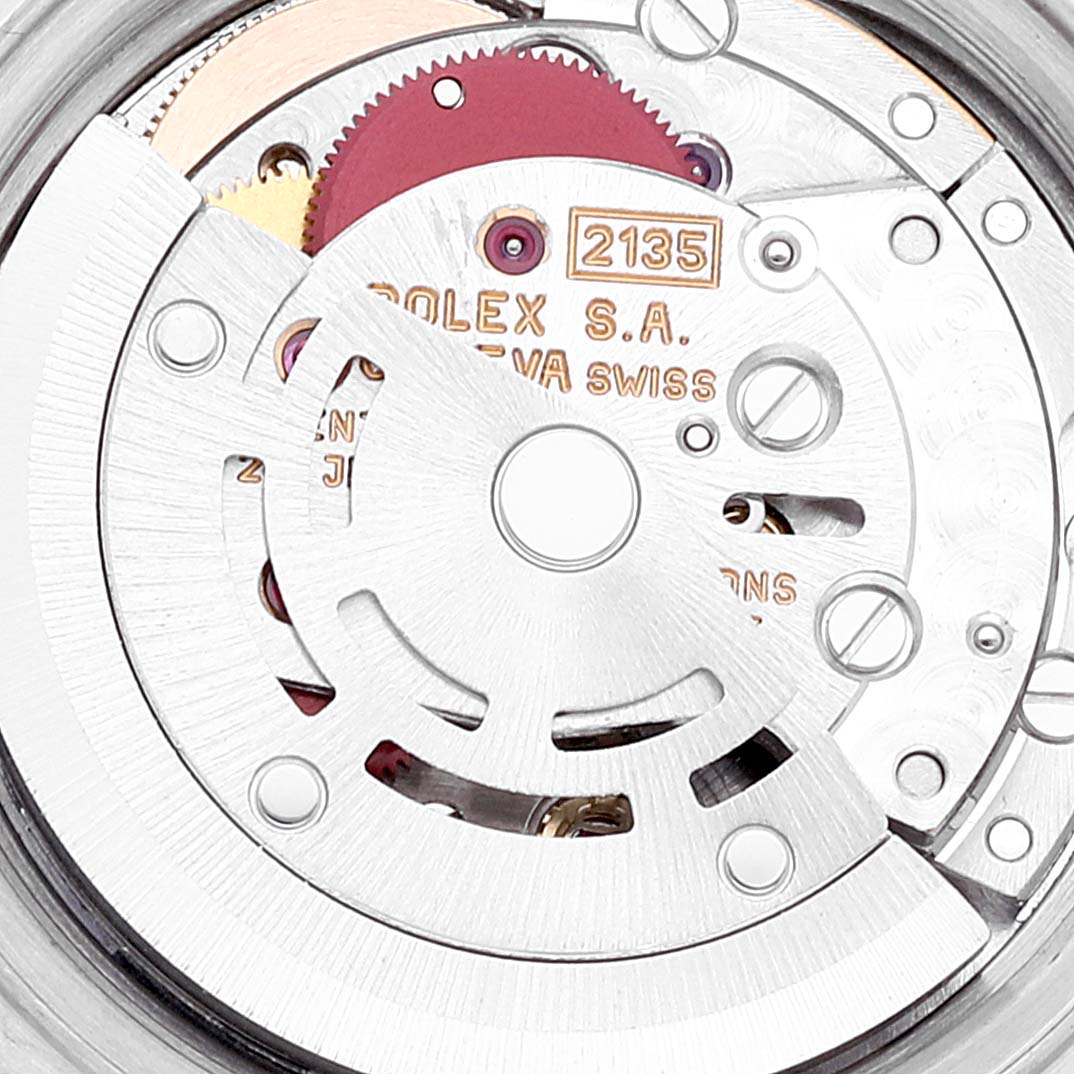 This image shows the movement mechanism of the Rolex Datejust 69173 Women's Steel and Gold (two tone) Blue Dial 69173 Women's Steel and Gold (two tone) Blue Dial watch from a close-up, angled view, displaying its intricate components and engravings.