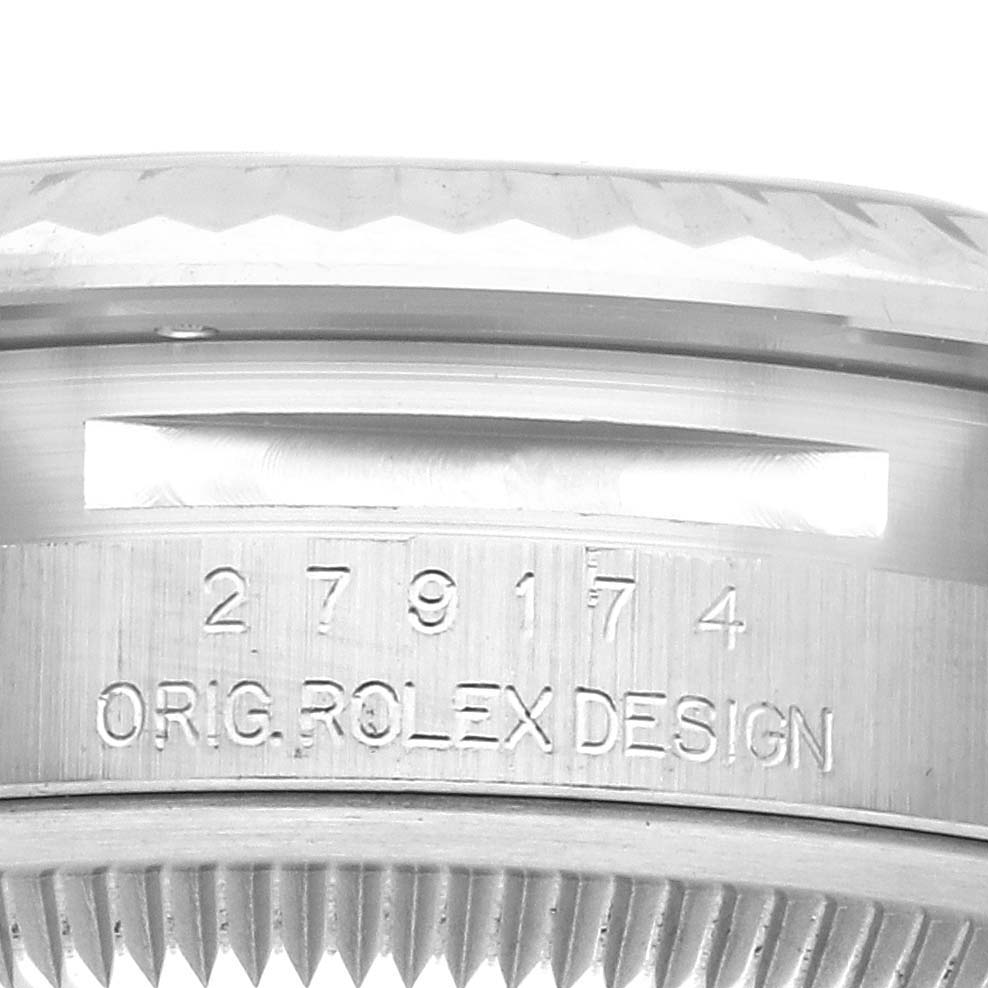 The image shows a detailed view of the Rolex Datejust 279174 Women's Stainless Steel Silver Dial 279174 Women's Stainless Steel Silver Dial model's case side with the serial number and "ORIG ROLEX DESIGN" engraving.