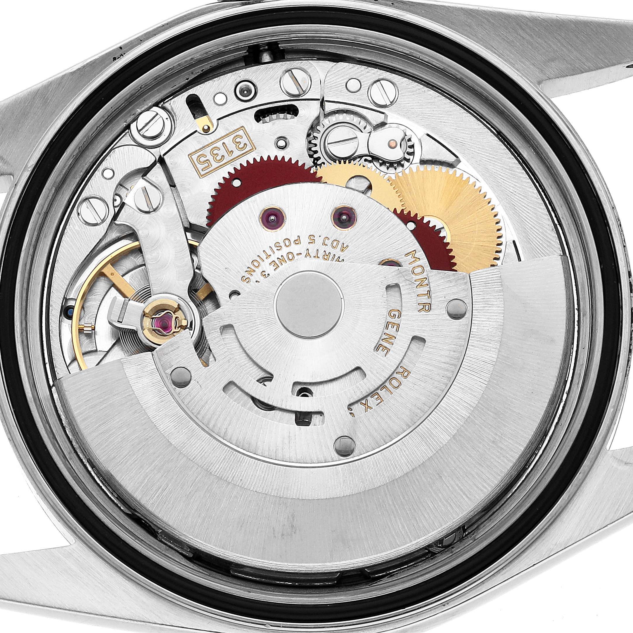 The image shows the movement mechanism of a Rolex Datejust 16234 Men's Stainless Steel Pink Dial watch from the back, highlighting gears and components.