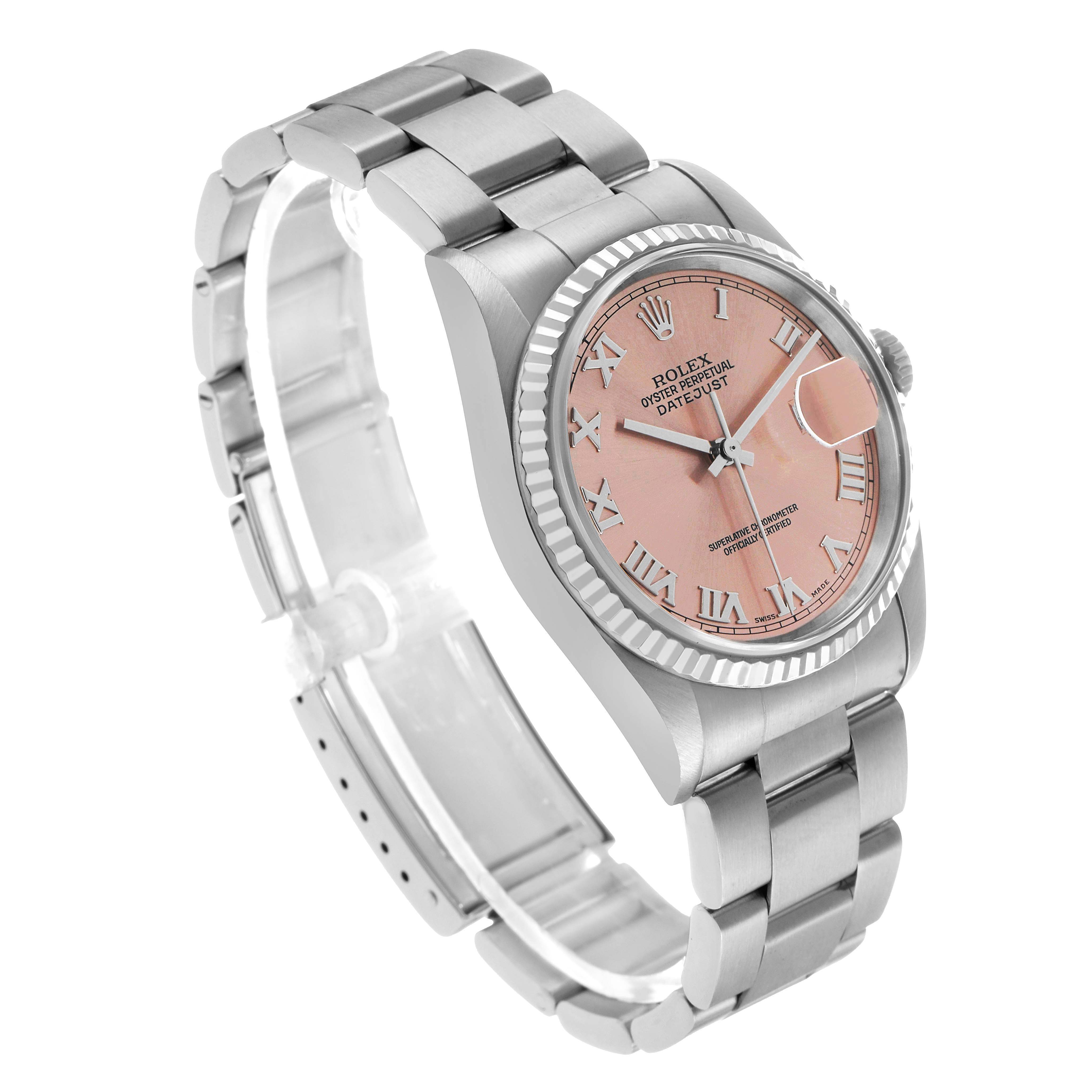 The Rolex Datejust 16234 Men's Stainless Steel Pink Dial watch is shown at a three-quarter angle, displaying its pink dial, Roman numerals, fluted bezel, and bracelet.