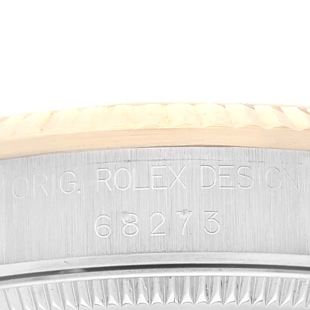 This image shows a close-up of the case side and bezel edge with the model number engraved on a Mid-Size Rolex watch.