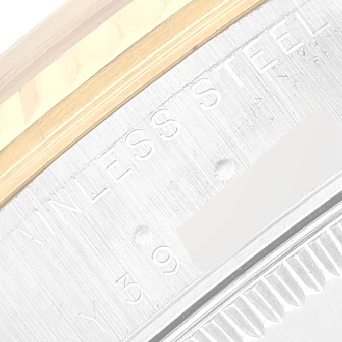 The image shows a close-up of the case edge and bezel of a Mid-Size Rolex watch, highlighting the stainless steel part and partial engraving.