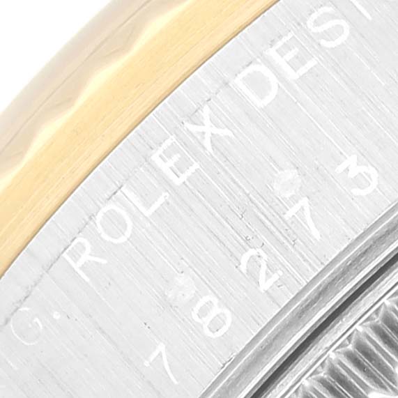 The image shows a close-up of the case back of a Mid-Size Rolex watch, highlighting the engraved model information and part of the bezel.