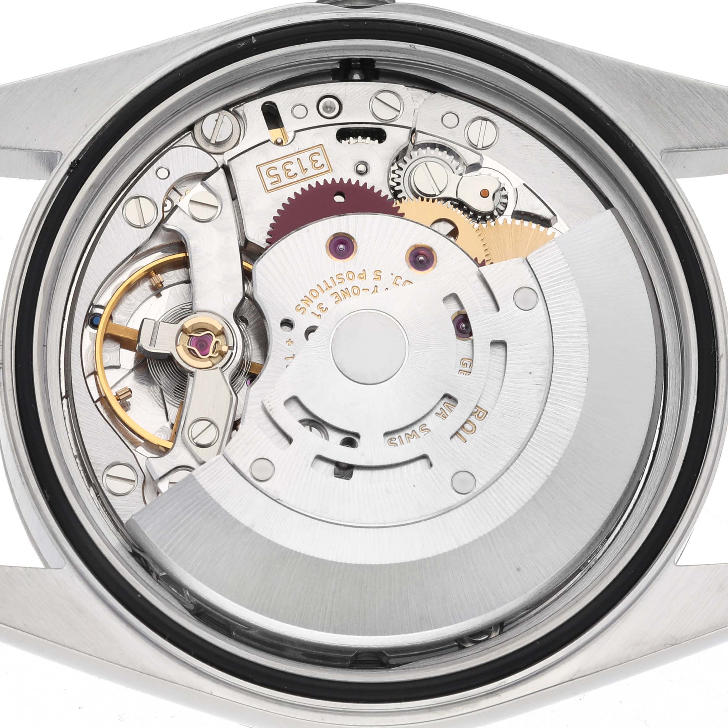 The image shows the back view of a Rolex Datejust 16220 Men's Stainless Steel Silver Dial 16220 Men's Stainless Steel Silver Dial, highlighting its intricate automatic movement and components.