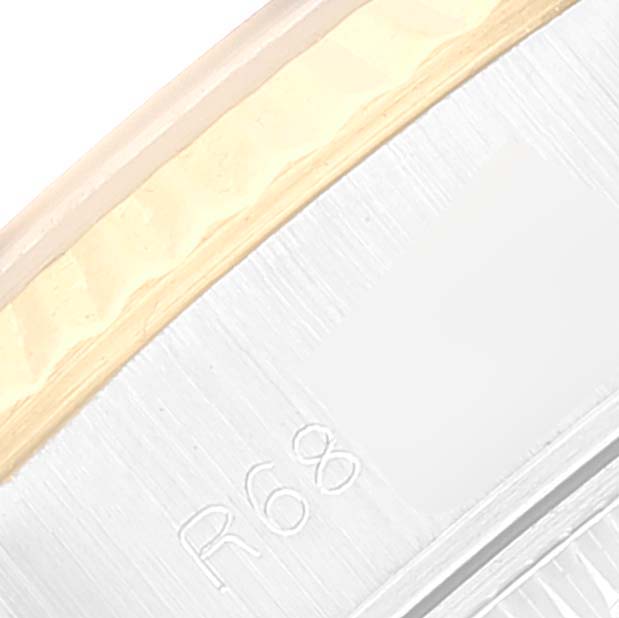 The image displays a close-up of the edge of the bezel and part of the band of a Rolex Datejust 69173 Women
s Steel and Gold (two tone) Grey Dial 69173 Women
s Steel and Gold (two tone) Grey Dial watch, showing the engraving "R 68."