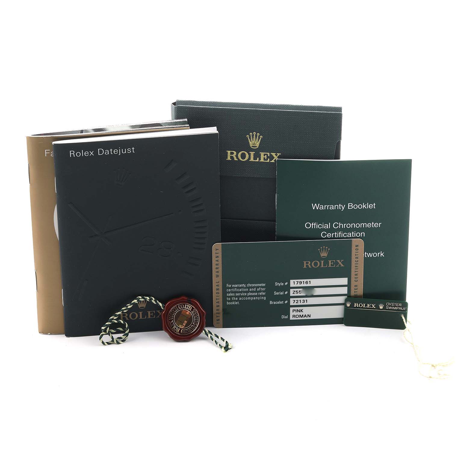 This image shows the accessories for the Rolex Datejust 179161 Women's Steel and Gold (two tone) Pink Dial, including booklets, a warranty card, and tags from a frontal angle.