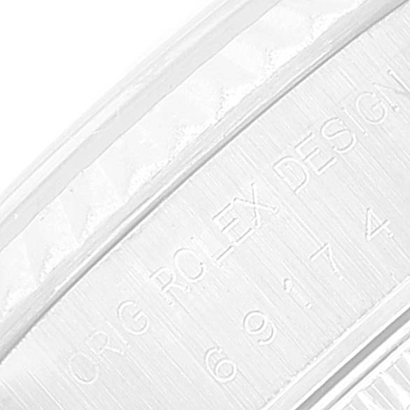 This image shows a close-up of the serial number engraving on the inner bezel of a Rolex Datejust 69174 Women's Stainless Steel Blue Dial 69174 Women's Stainless Steel Blue Dial watch.