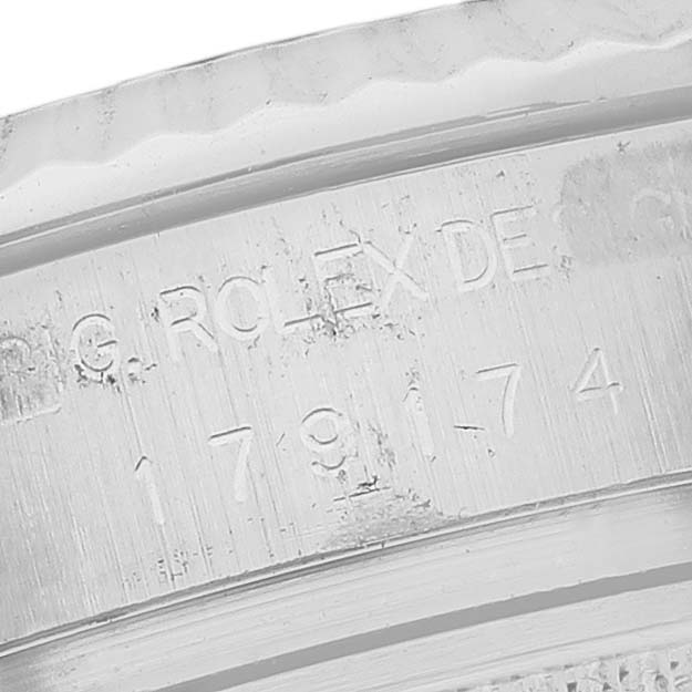 This image shows a close-up view of the engraved inner bezel of a Rolex Datejust 179174 Women's Stainless Steel Silver Dial 179174 Women's Stainless Steel Silver Dial watch.