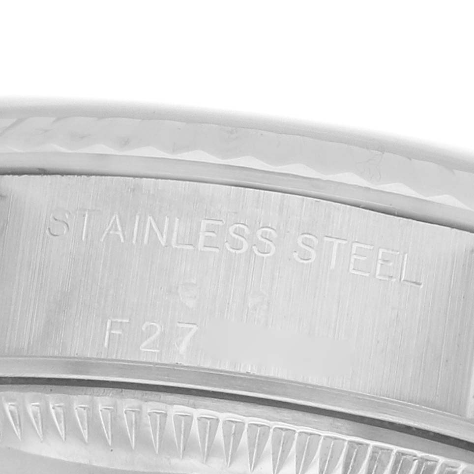 The image shows a close-up of the stainless steel engraving on the side of a Rolex Datejust 79174 Women's Stainless Steel Pink Dial watch case.