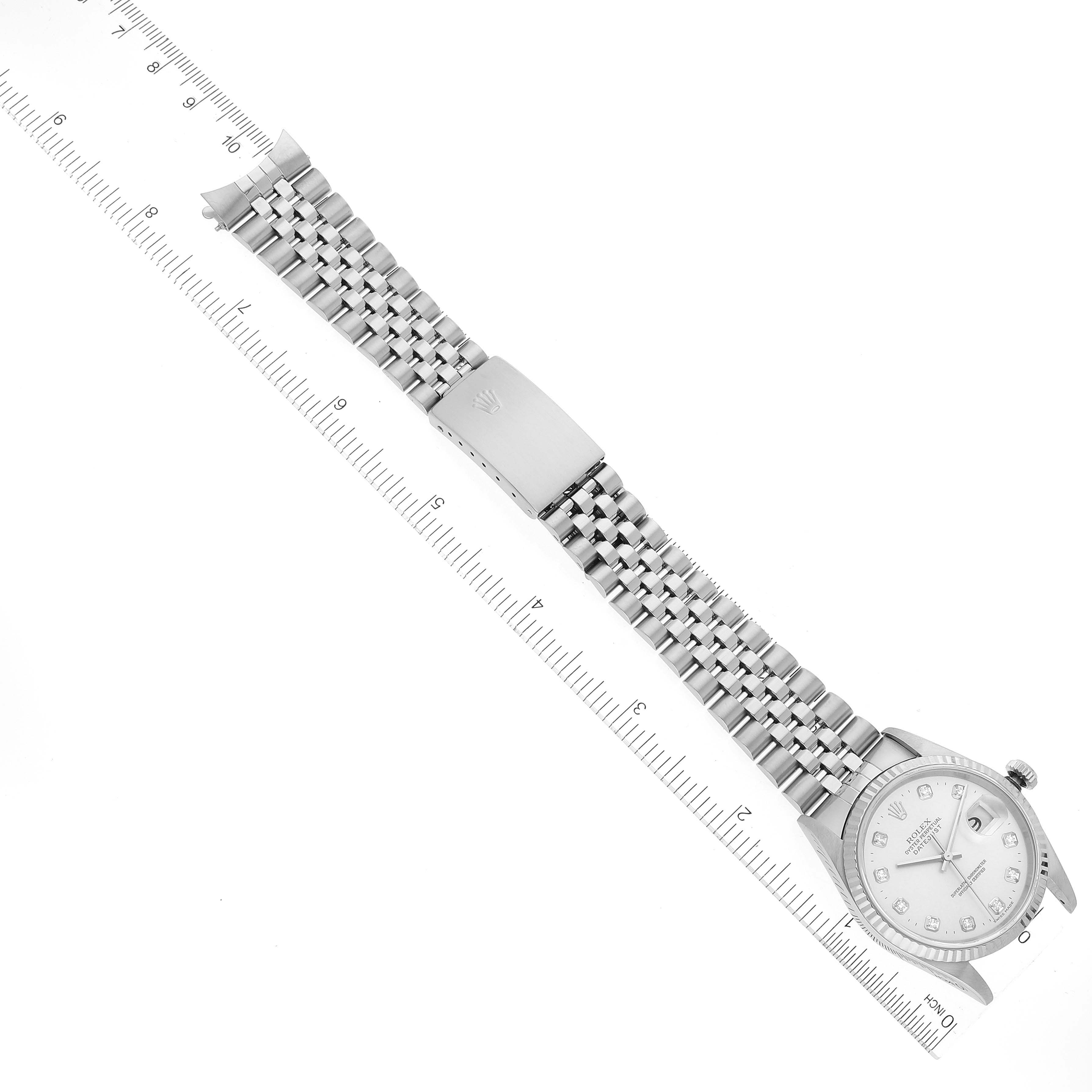 The image shows a Rolex Datejust 16234 Men's Stainless Steel Silver Dial 16234 Men's Stainless Steel Silver Dial watch laid flat with its dial, bracelet, and clasp visible, alongside a ruler for measurement.