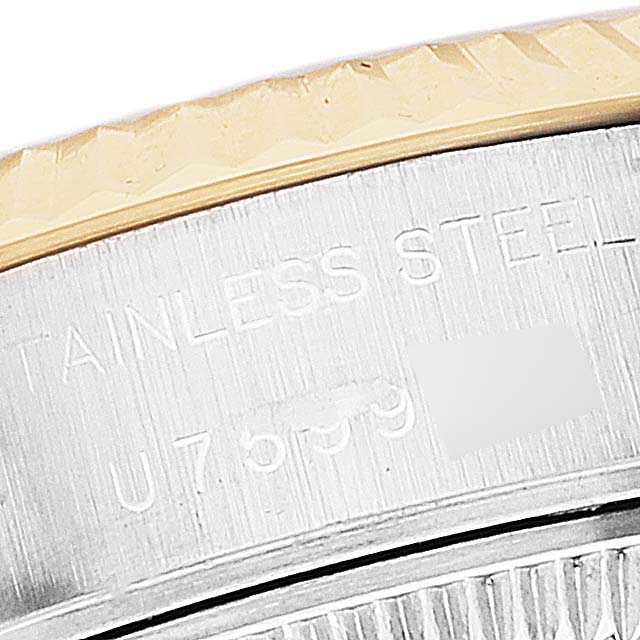 This close-up image shows the edge of the bezel and part of the case back of a Rolex Datejust 69173 Women's Steel and Gold (two tone) Blue Dial 69173 Women's Steel and Gold (two tone) Blue Dial watch, displaying the serial number.