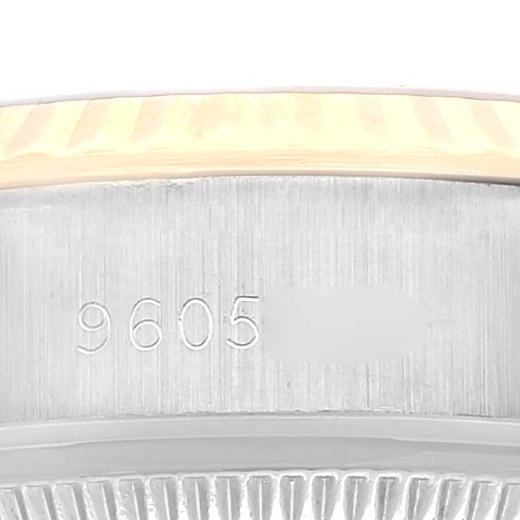 This image shows a close-up of the side of a Rolex Datejust 69173 Women's Steel and Gold (two tone) Champagne Dial 69173 Women's Steel and Gold (two tone) Champagne Dial watch, highlighting its serial number and edge of the bezel.