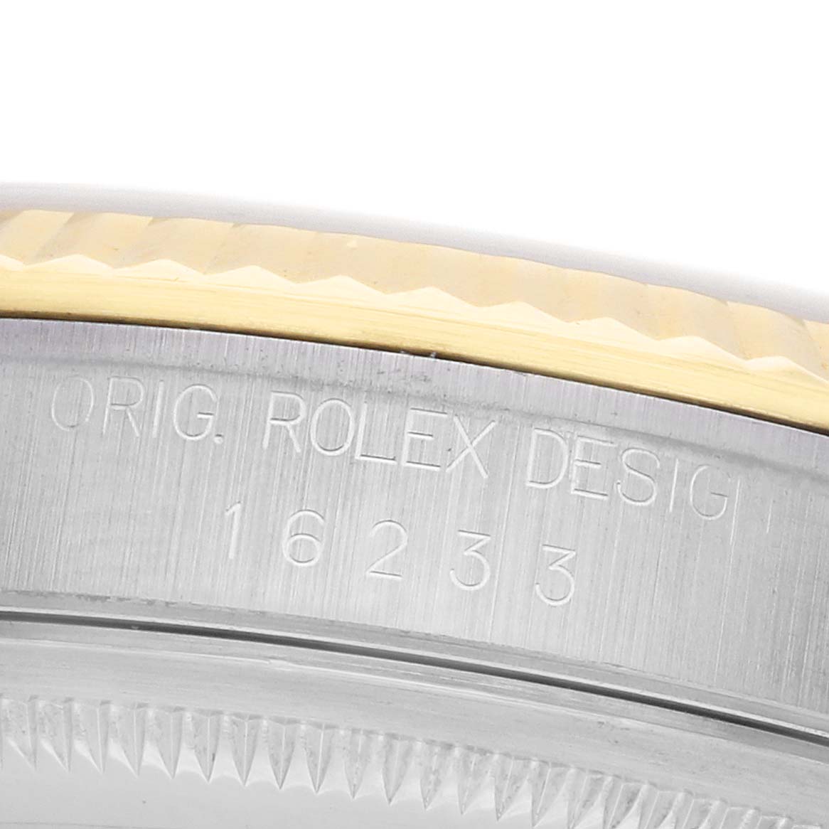 The image shows the side of a Rolex Datejust 16233 Men's Steel and Gold (two tone) Beige Dial watch case, highlighting the engraved model number and the fluted bezel edge.
