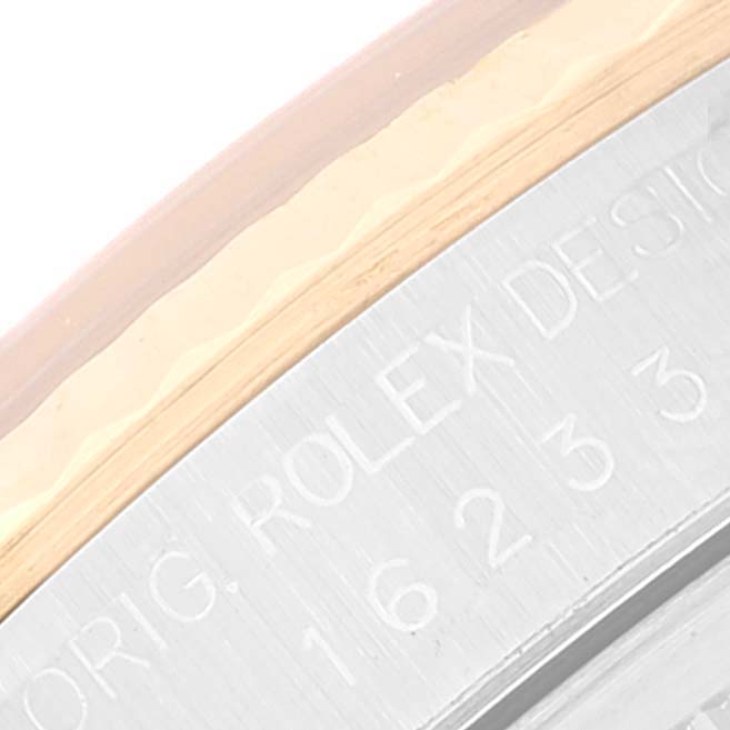 This image shows a close-up of the engraved bezel and case edge of a Rolex Datejust 16233 Men's Steel and Gold (two tone) Silver Dial 16233 Men's Steel and Gold (two tone) Silver Dial watch.