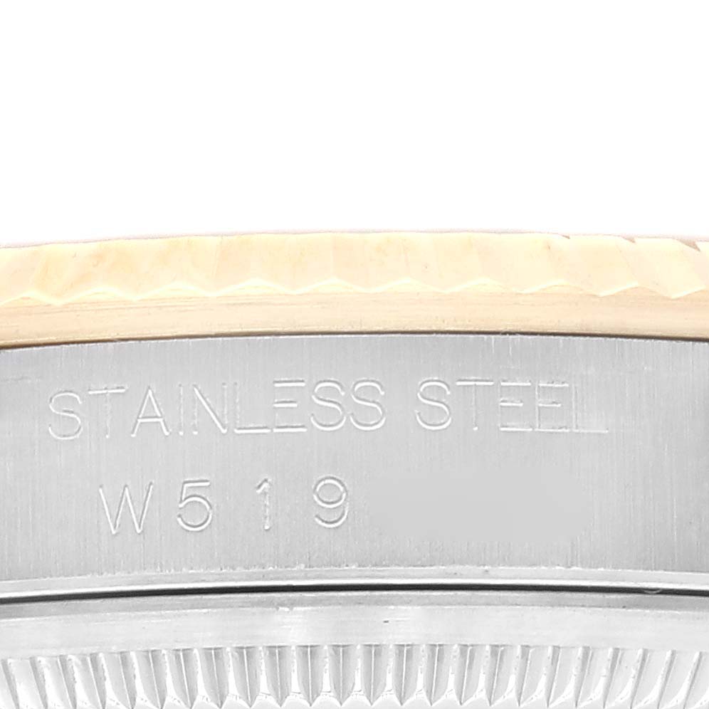 This close-up image shows the side of a stainless steel Rolex Datejust 16233 Men's Steel and Gold (two tone) White Dial 16233 Men's Steel and Gold (two tone) White Dial watch, specifically focusing on the bezel and case.