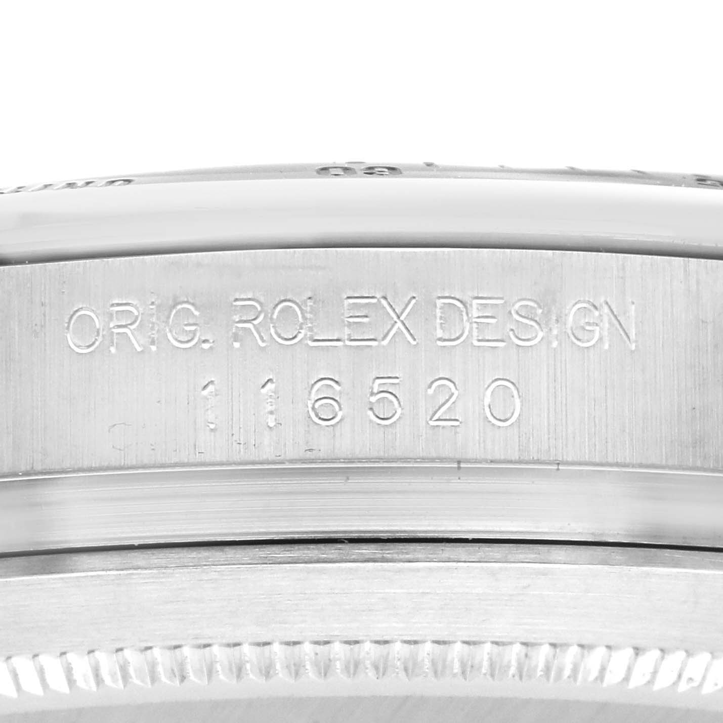 The image shows a close-up of the side of a Rolex Daytona 116520 Men
s Stainless Steel White Dial 116520 Men
s Stainless Steel White Dial watch, displaying the model number engraving.