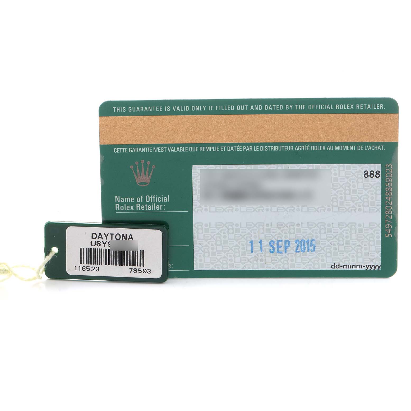 The image shows a warranty card and tag for a Rolex Daytona 116523 Men's Steel and Gold (two tone) Blue Dial, displaying a date and serial number.