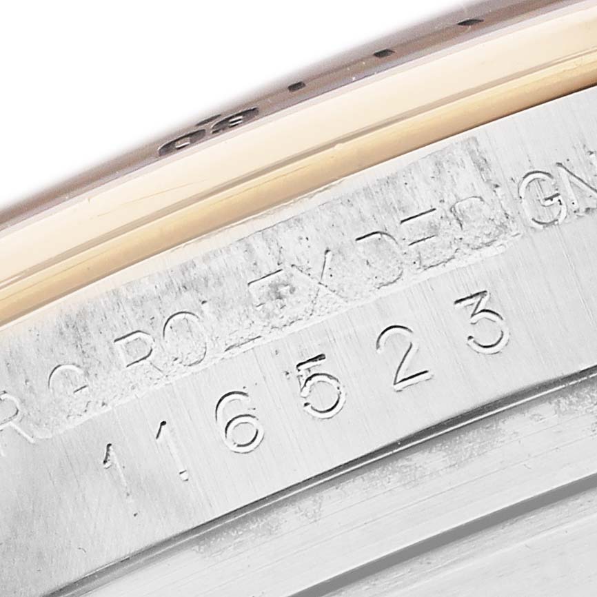 The image shows a close-up of the engraved side of the Rolex Daytona 116523 Men's Steel and Gold (two tone) Blue Dial model, highlighting the serial number.