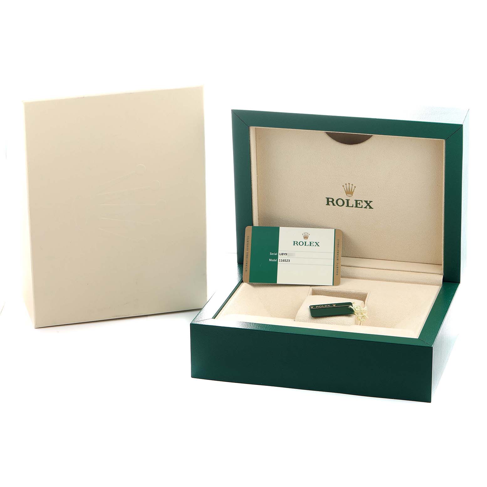 The image shows the open packaging and box for a Rolex Daytona 116523 Men's Steel and Gold (two tone) Blue Dial watch, highlighting the branding and accessory compartments.