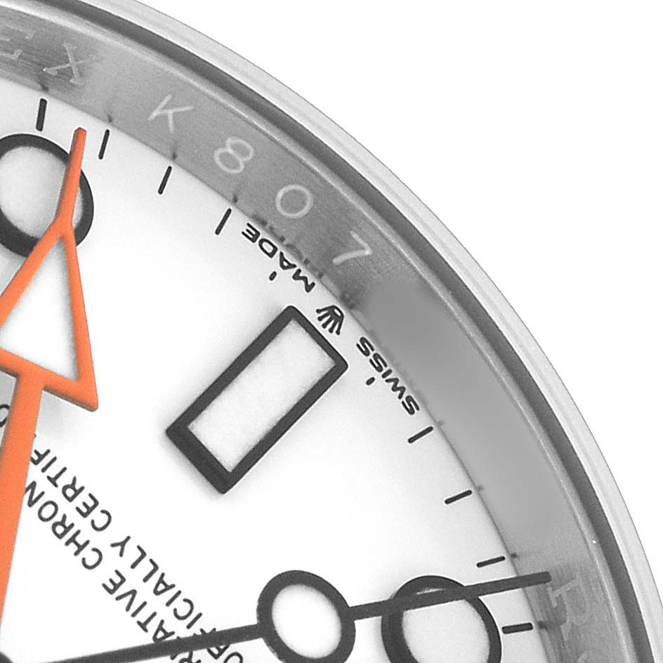 This close-up shows a portion of the dial and orange hand of a Rolex Explorer 226570 Men's Stainless Steel White Dial, highlighting the "Swiss Made" text.