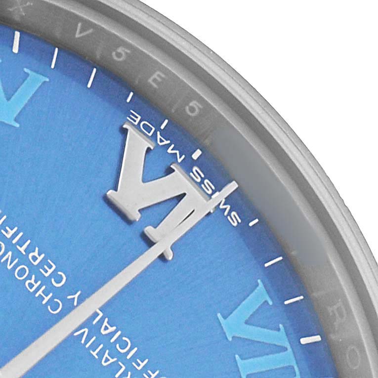 The image shows a close-up of a Rolex Mid-Size 177200 Women's Stainless Steel Blue Dial watch, highlighting its blue dial, Roman numeral VI, and minute markings.