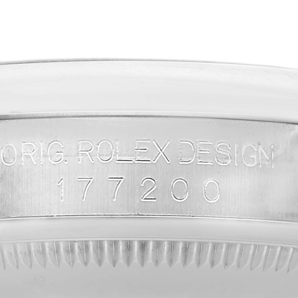 The image shows a close-up of the side of a Rolex Oyster Perpetual 177200 Women's Stainless Steel Blue Dial watch, highlighting the engraved design and model number.
