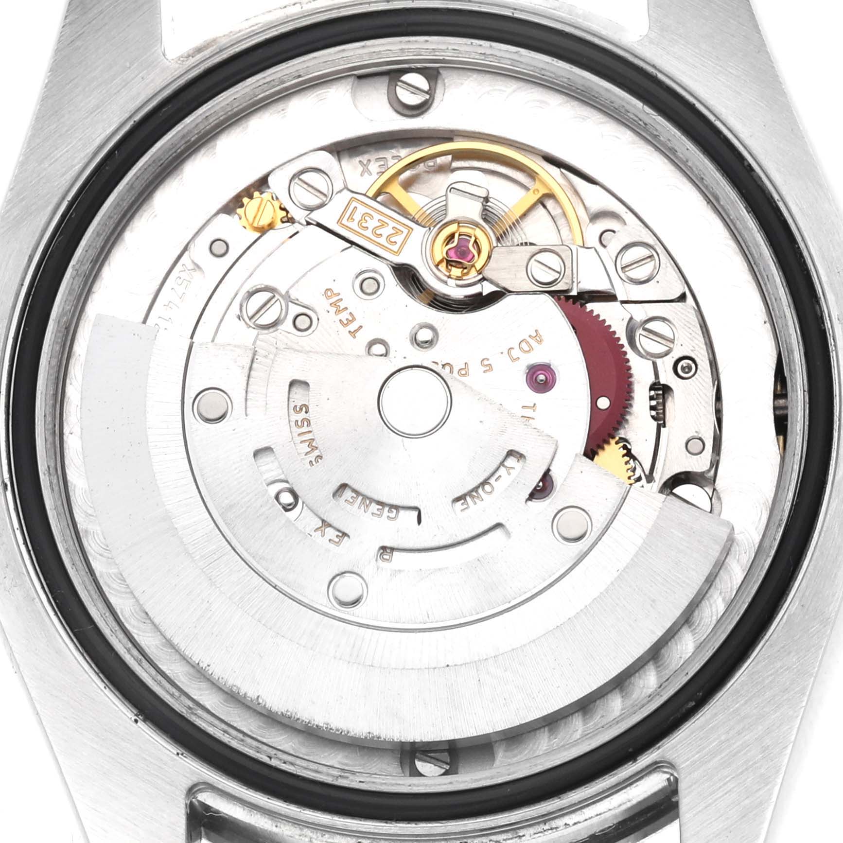 The image shows a close-up of the movement inside a Rolex Oyster Perpetual 177200 Women's Stainless Steel Blue Dial watch, highlighting its intricate mechanical parts.