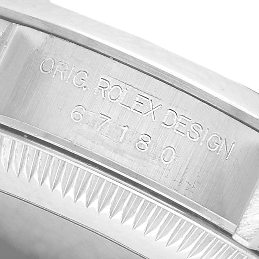 The image shows the side engraving on the case of a Rolex Oyster Perpetual 67180 Women's Stainless Steel Blue Dial, displaying the original design and model number.