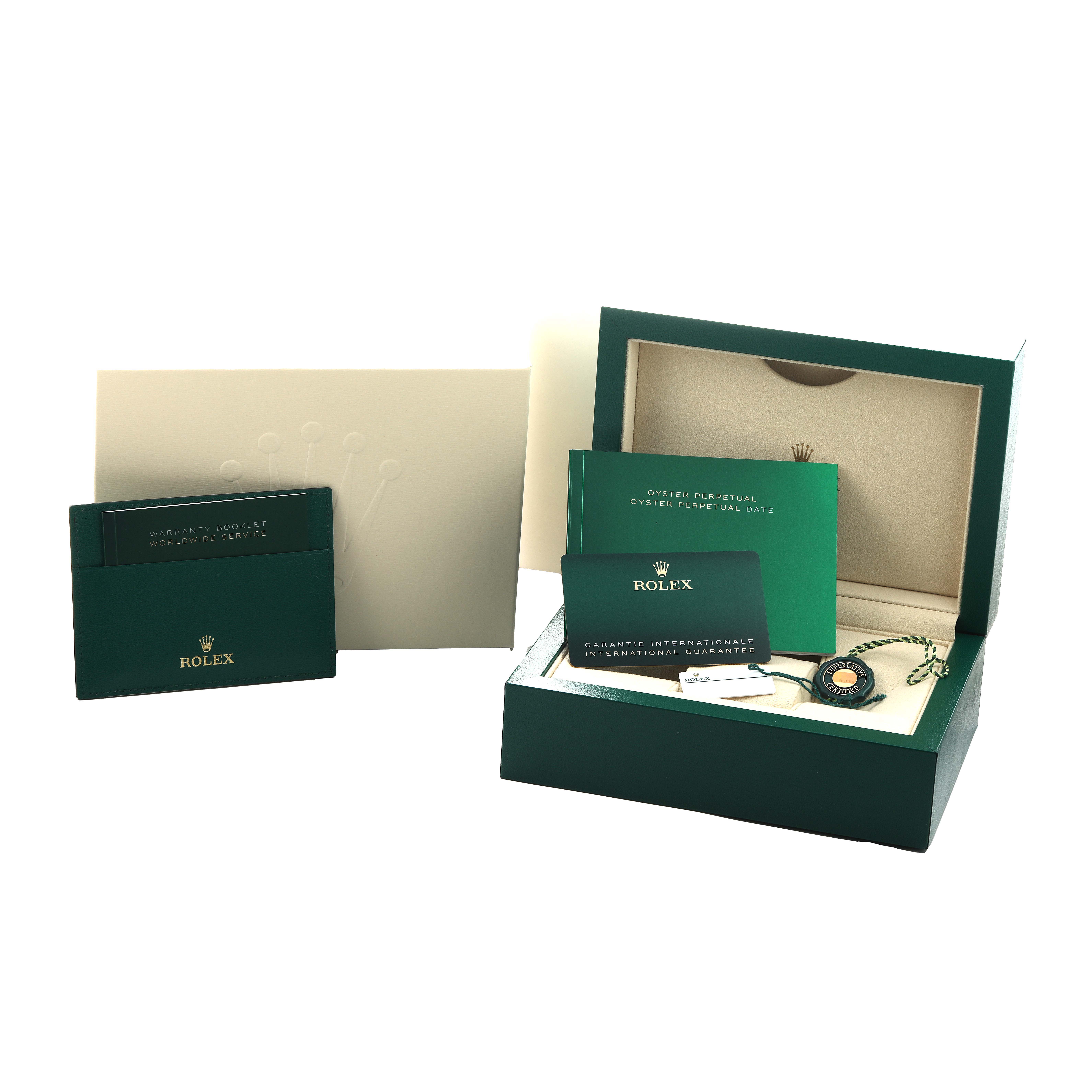 The image shows accessories for the Rolex Oyster Perpetual 126000 Men's Stainless Steel Blue Dial, including a box, guarantee card, and booklets.