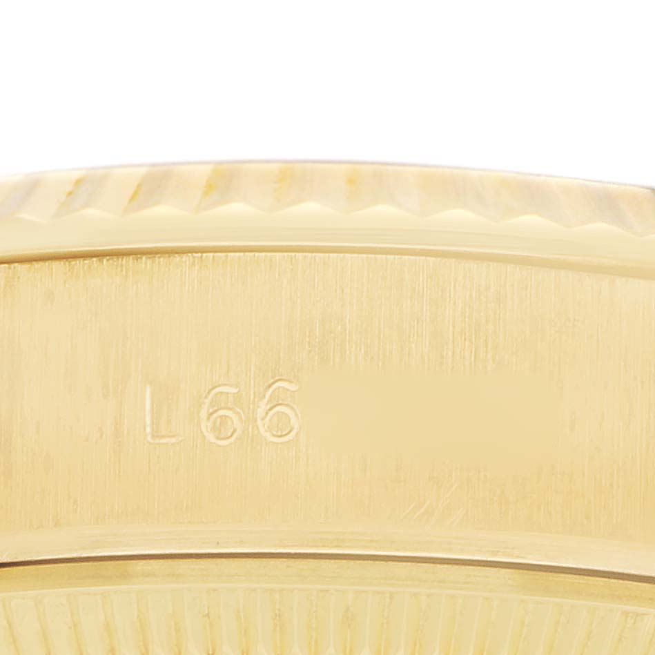 The image shows a close-up of the Rolex President 69178 Women's Yellow Gold Blue Dial's side case, featuring engraved details.