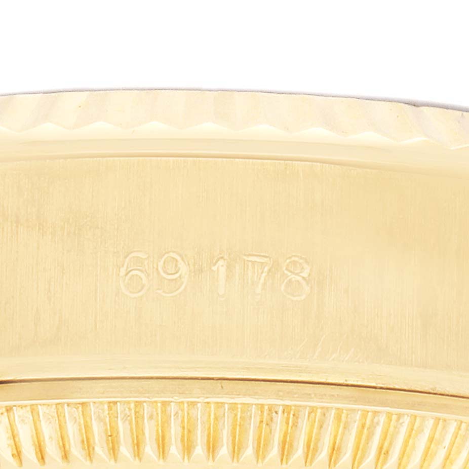The image shows the side profile of a Rolex President 69178 Women's Yellow Gold Blue Dial model, highlighting the serial number on its case and the edge of the bezel.