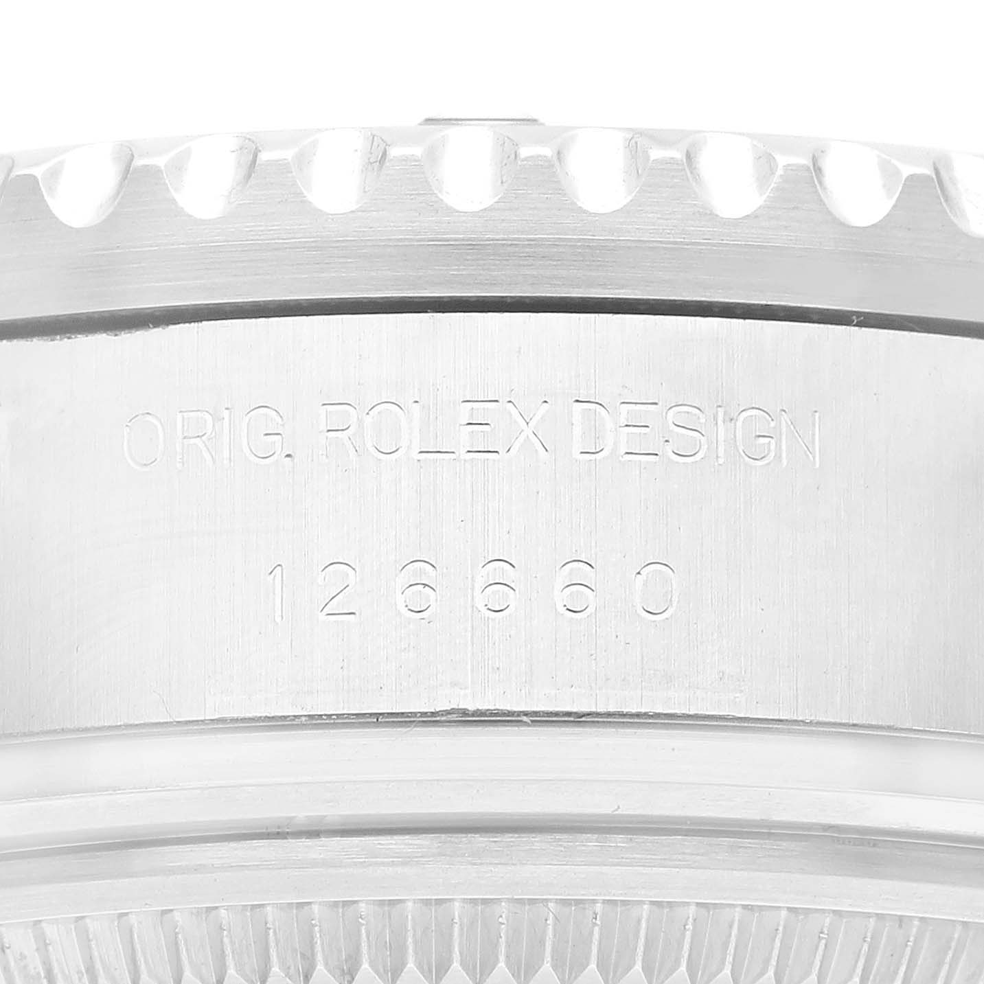 This close-up image of the Sea-Dweller Rolex watch focuses on its casing, showcasing the engravings and serrated bezel.