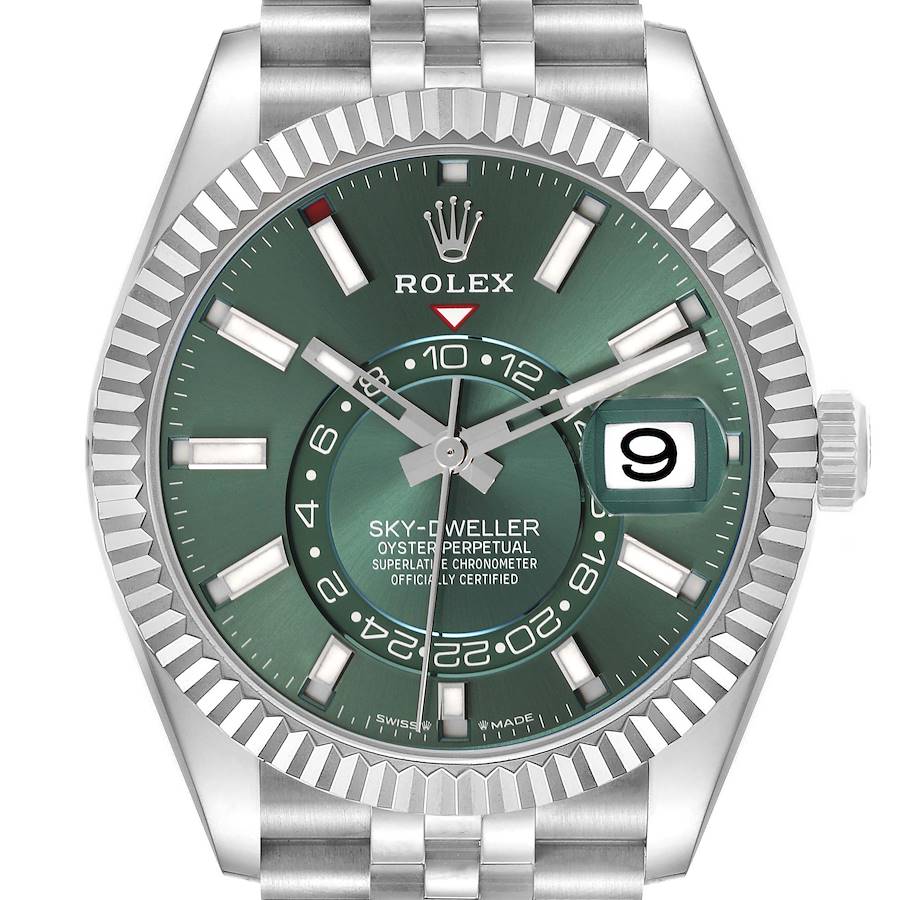 The Rolex Sky-Dweller is shown from the front, displaying its green dial, bezel, hands, date, and part of the bracelet.