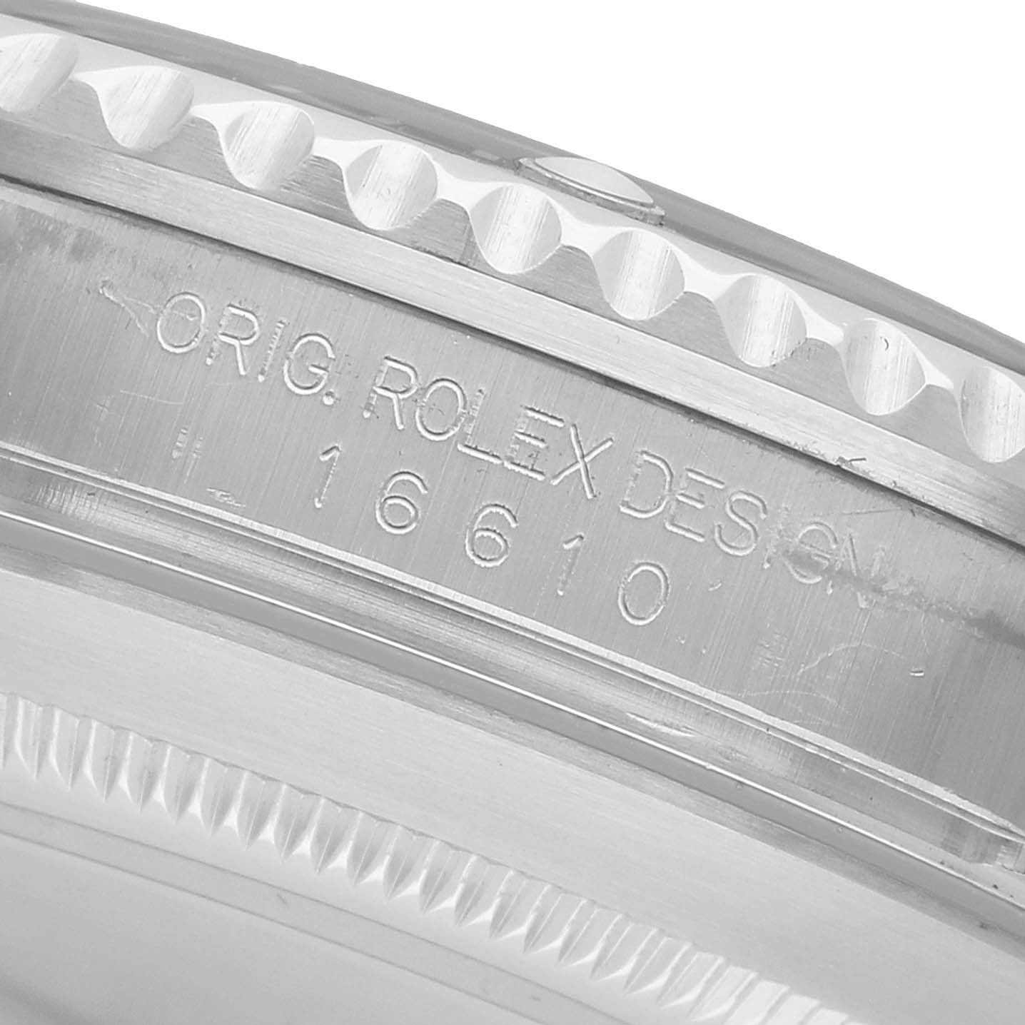 The image shows the side view of a Rolex Submariner 16610 Men's Stainless Steel Black Dial, highlighting the engraved model number and design stamp.