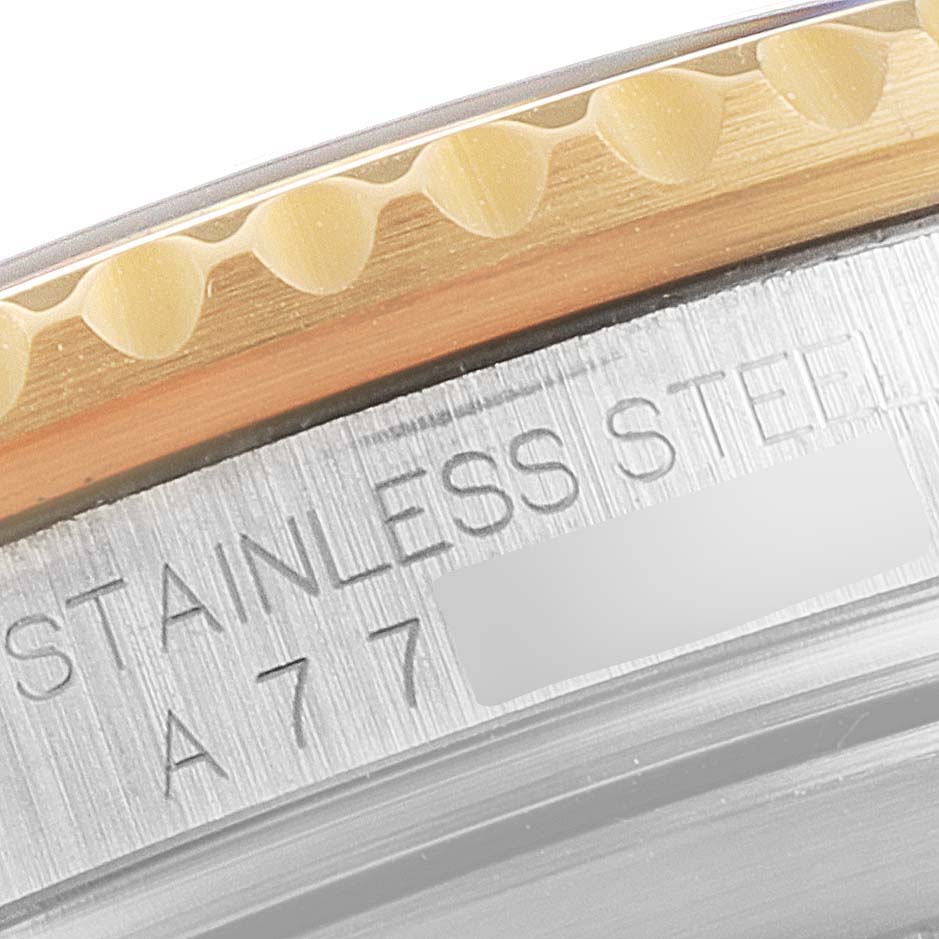 This close-up angle shows the edge of the bezel and part of the case of a Rolex Submariner 16613 Men
s Steel and Gold (two tone) Blue Dial 16613 Men
s Steel and Gold (two tone) Blue Dial watch, revealing "STAINLESS STEEL" engraving.