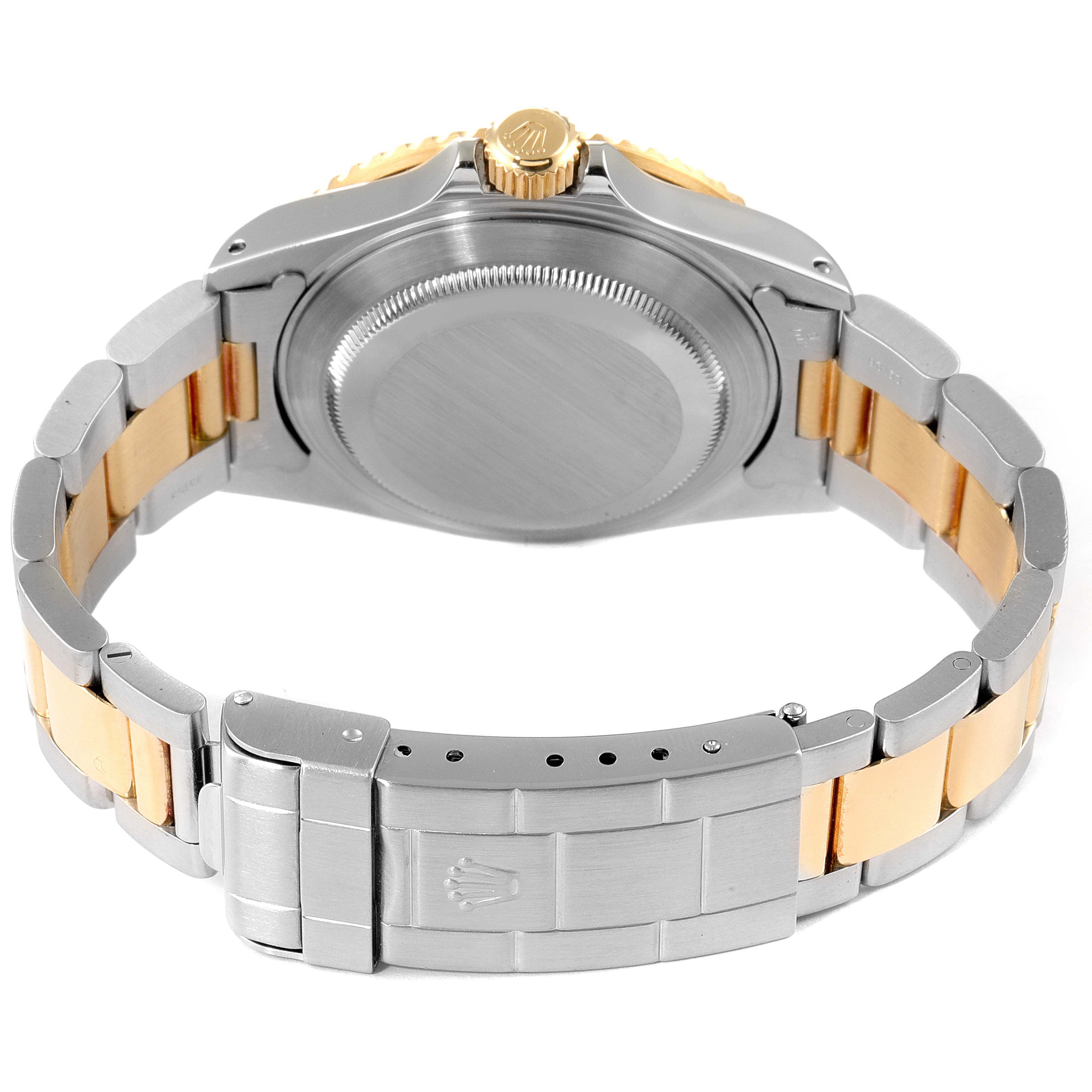 The image shows the back view of a Rolex Submariner 16613 Men
s Steel and Gold (two tone) Blue Dial 16613 Men
s Steel and Gold (two tone) Blue Dial, highlighting the case back, crown, and two-tone bracelet.