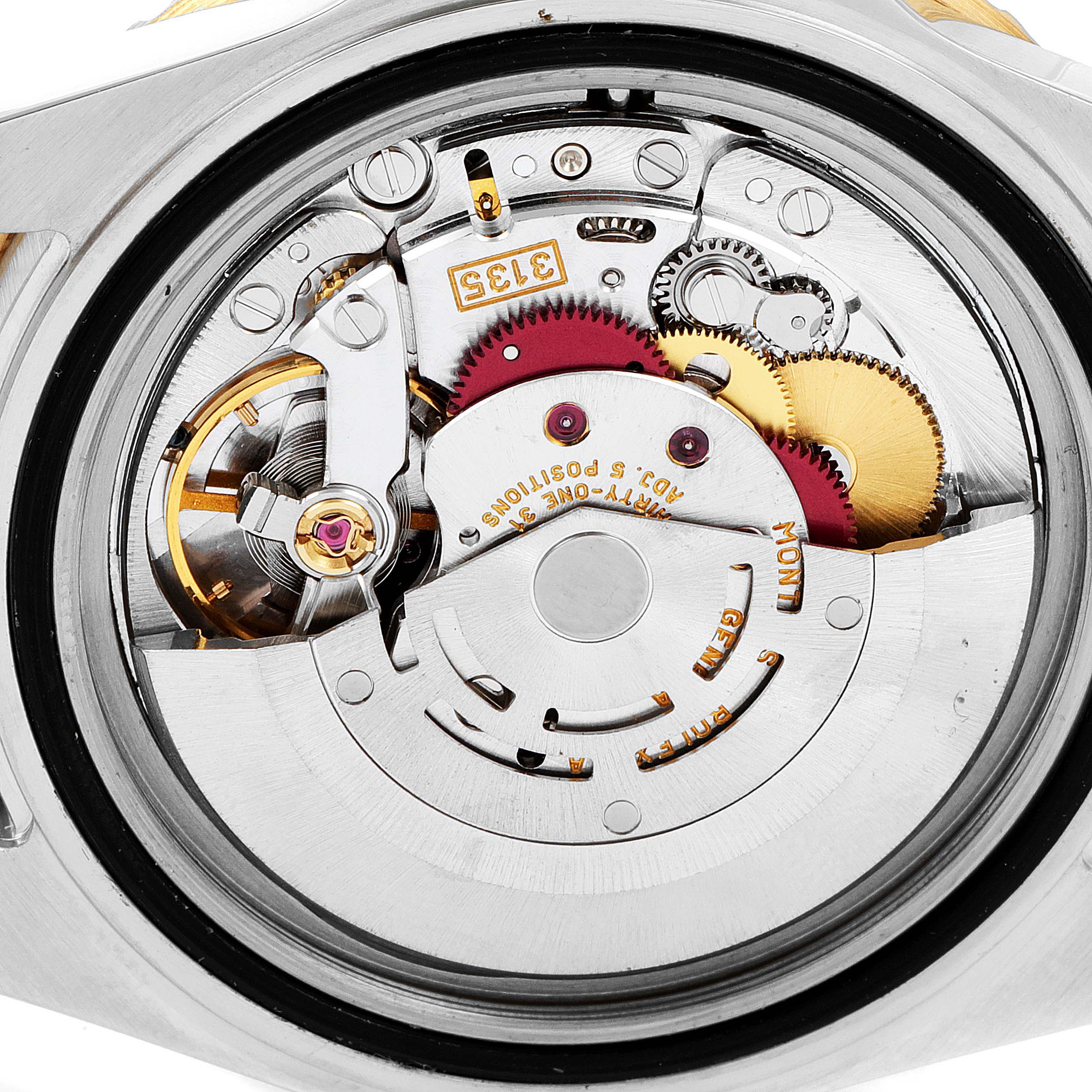 This image shows a close-up of the mechanical movement inside a Rolex Submariner 16613 Men
s Steel and Gold (two tone) Blue Dial 16613 Men
s Steel and Gold (two tone) Blue Dial watch, highlighting its intricate gears and components.