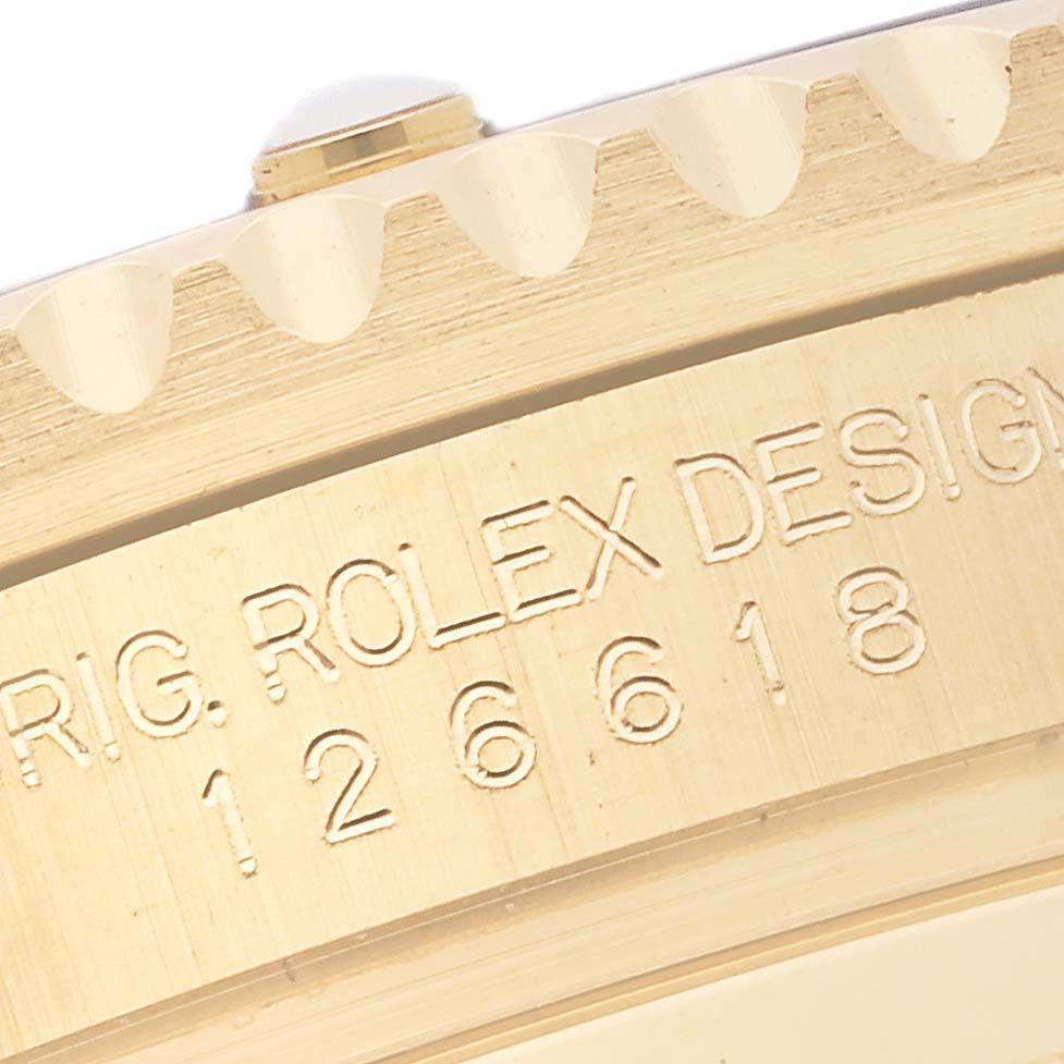 The image shows a close-up of the side engraving on the bezel of a Rolex Submariner 126618 Men's Yellow Gold Black Dial 126618 Men's Yellow Gold Black Dial watch.