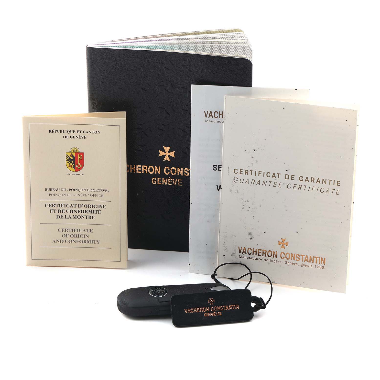 The image shows Vacheron Constantin Historiques 86122/000R-9362 Men's Rose Gold White Dial watch accessories, including booklets, a certificate, and tags, seen from the front.