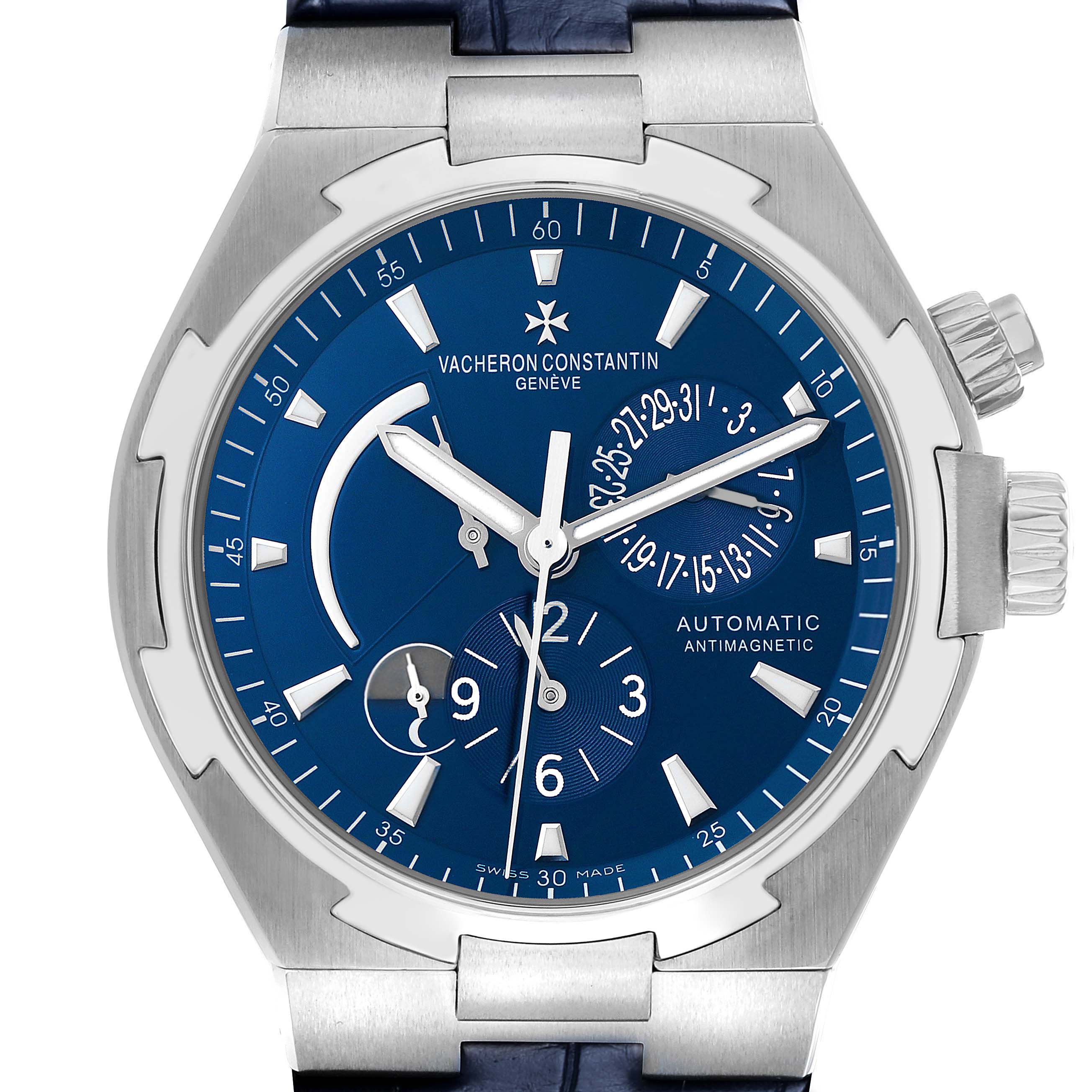 The Vacheron Constantin Overseas 47450 Men's Stainless Steel Blue Dial watch is shown from the front, displaying the blue dial, hands, subdials, and crown.