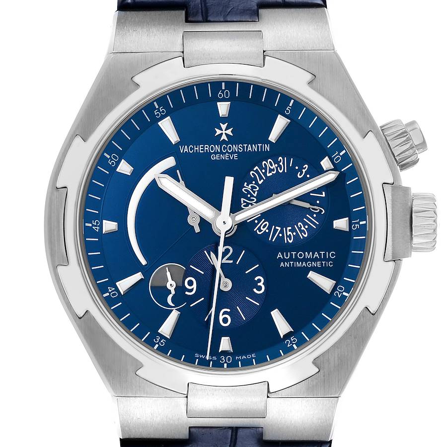 The Vacheron Constantin Overseas 47450 Men's Stainless Steel Blue Dial watch is shown from the front, displaying the blue dial, hands, subdials, and crown.