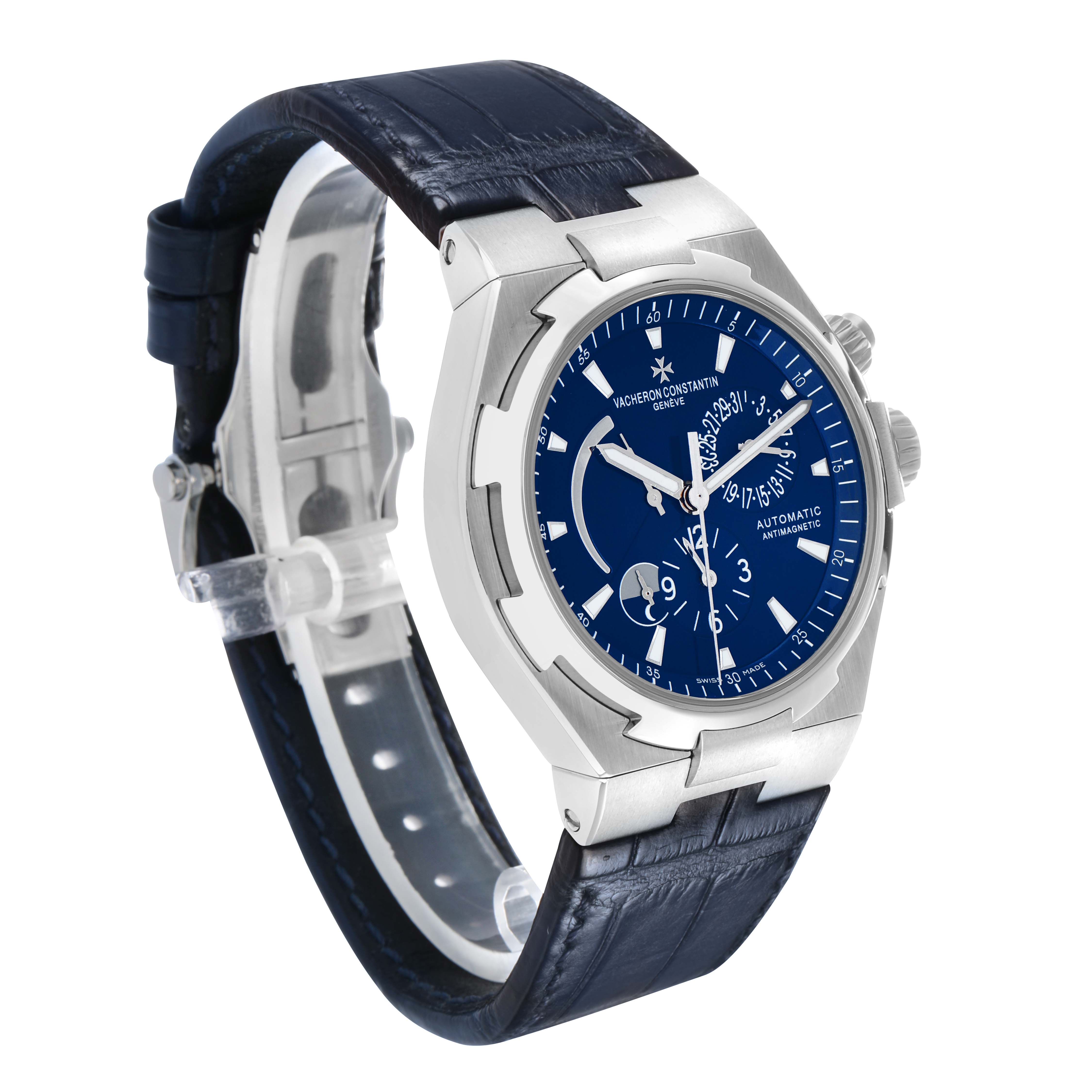 The Vacheron Constantin Overseas 47450 Men's Stainless Steel Blue Dial watch is shown at a three-quarter angle, highlighting the blue dial, bezel, and leather strap.