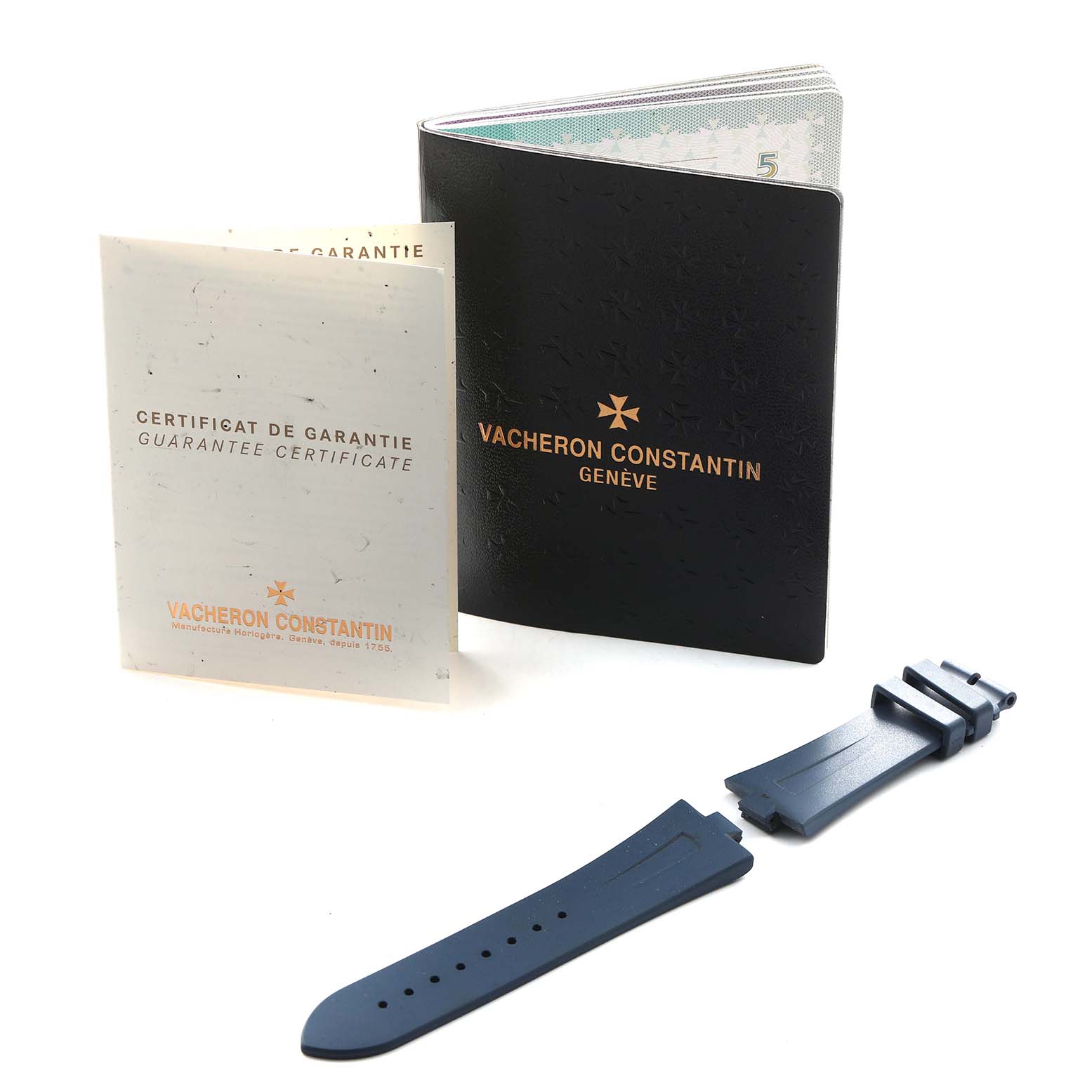 The image shows documentation and a blue rubber strap for a Vacheron Constantin Overseas 47450 Men's Stainless Steel Blue Dial watch.