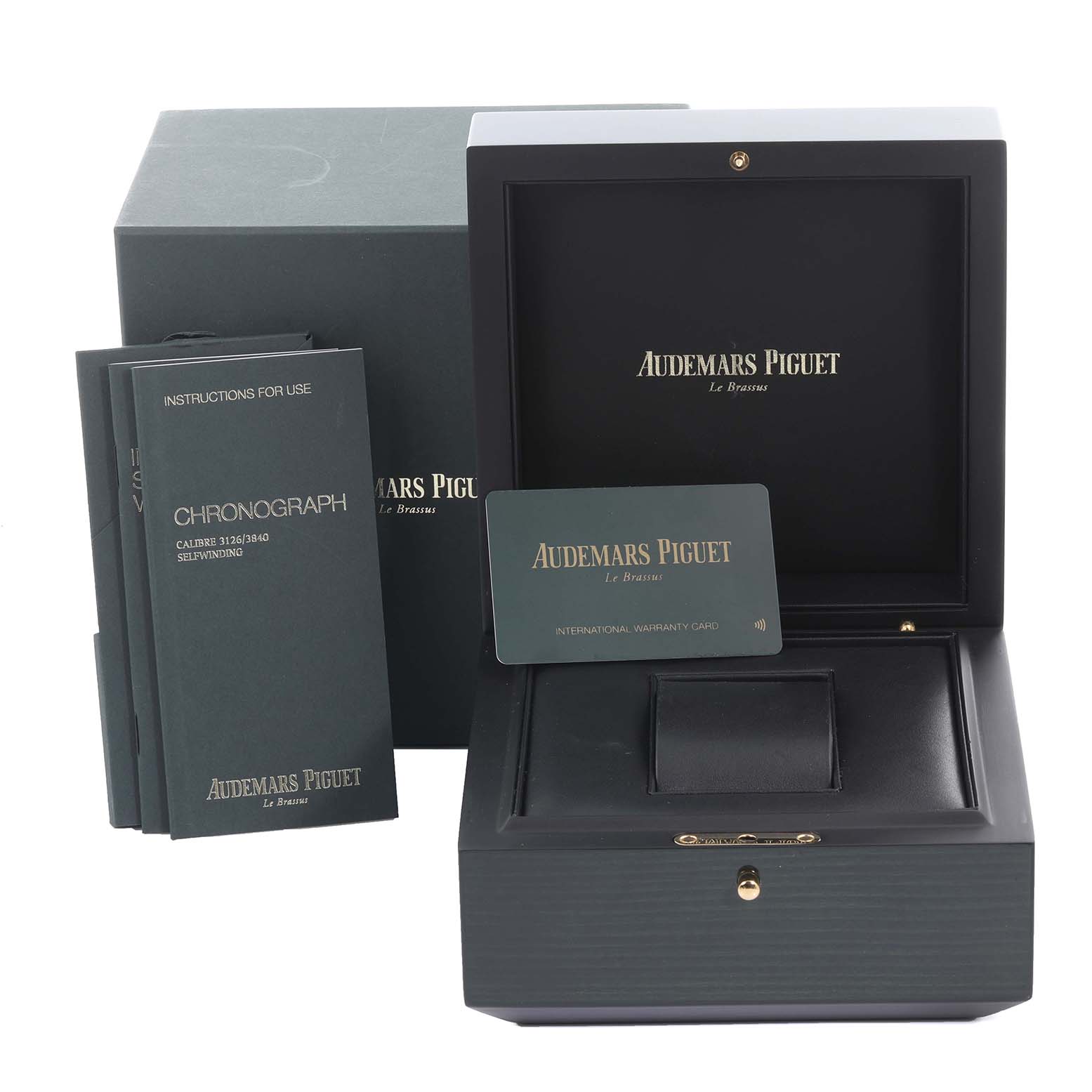 The image shows a Royal Oak Offshore box set by Audemars Piguet, including the box, manuals, and warranty card.