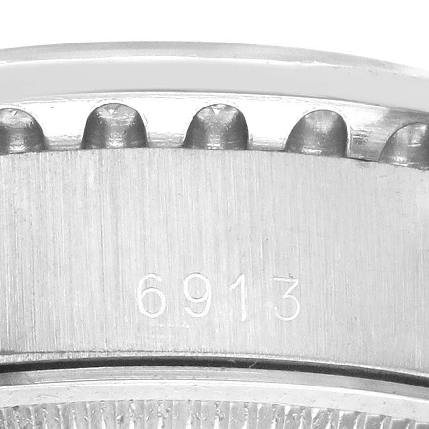 The image shows a close-up of the bezel and side of the Rolex President 6913 Women's White Gold Blue Dial 6913 Women's White Gold Blue Dial model watch, displaying the reference number 6913.