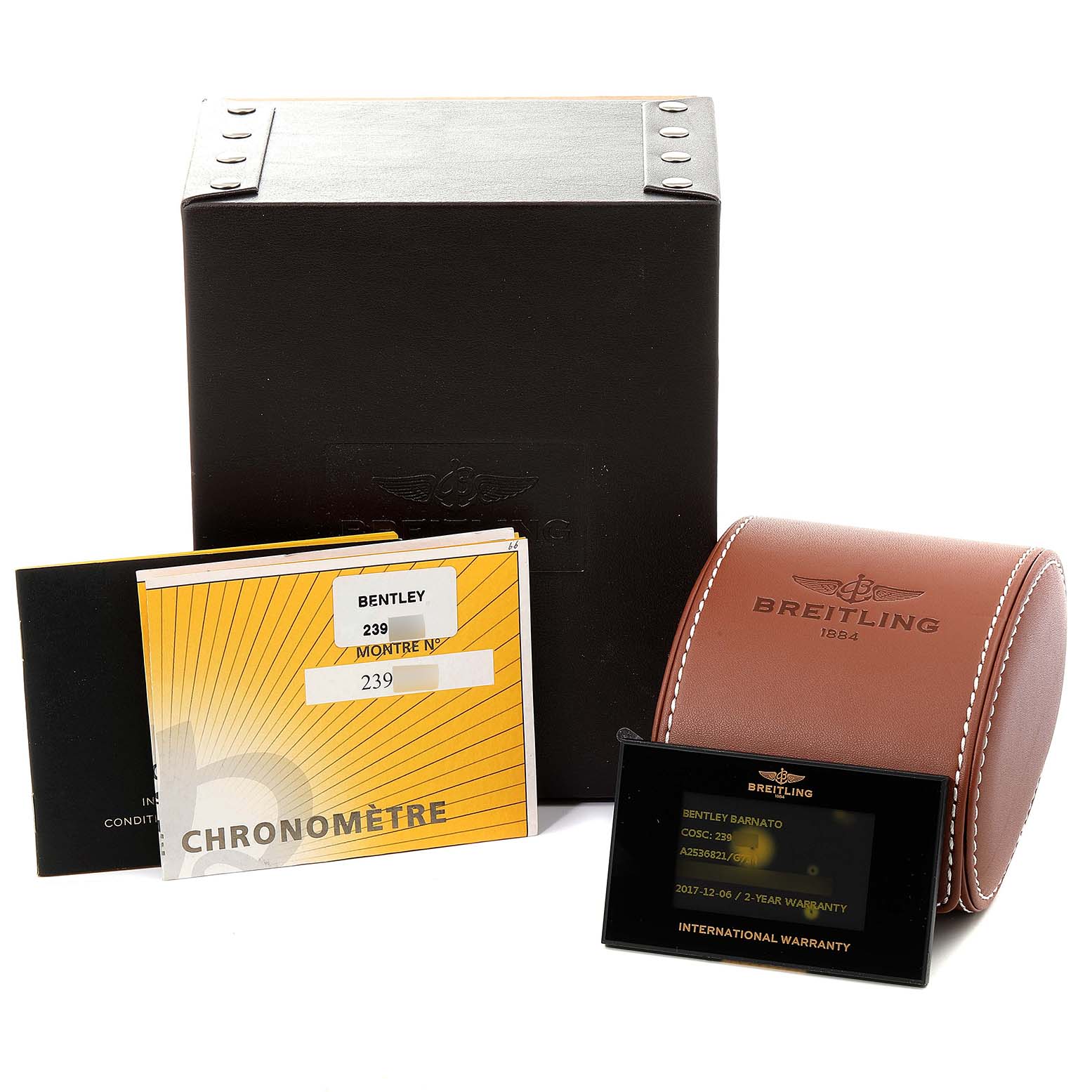 The image shows the box and accessories of the Bentley model by Breitling, including manuals, a leather case, and a warranty card.