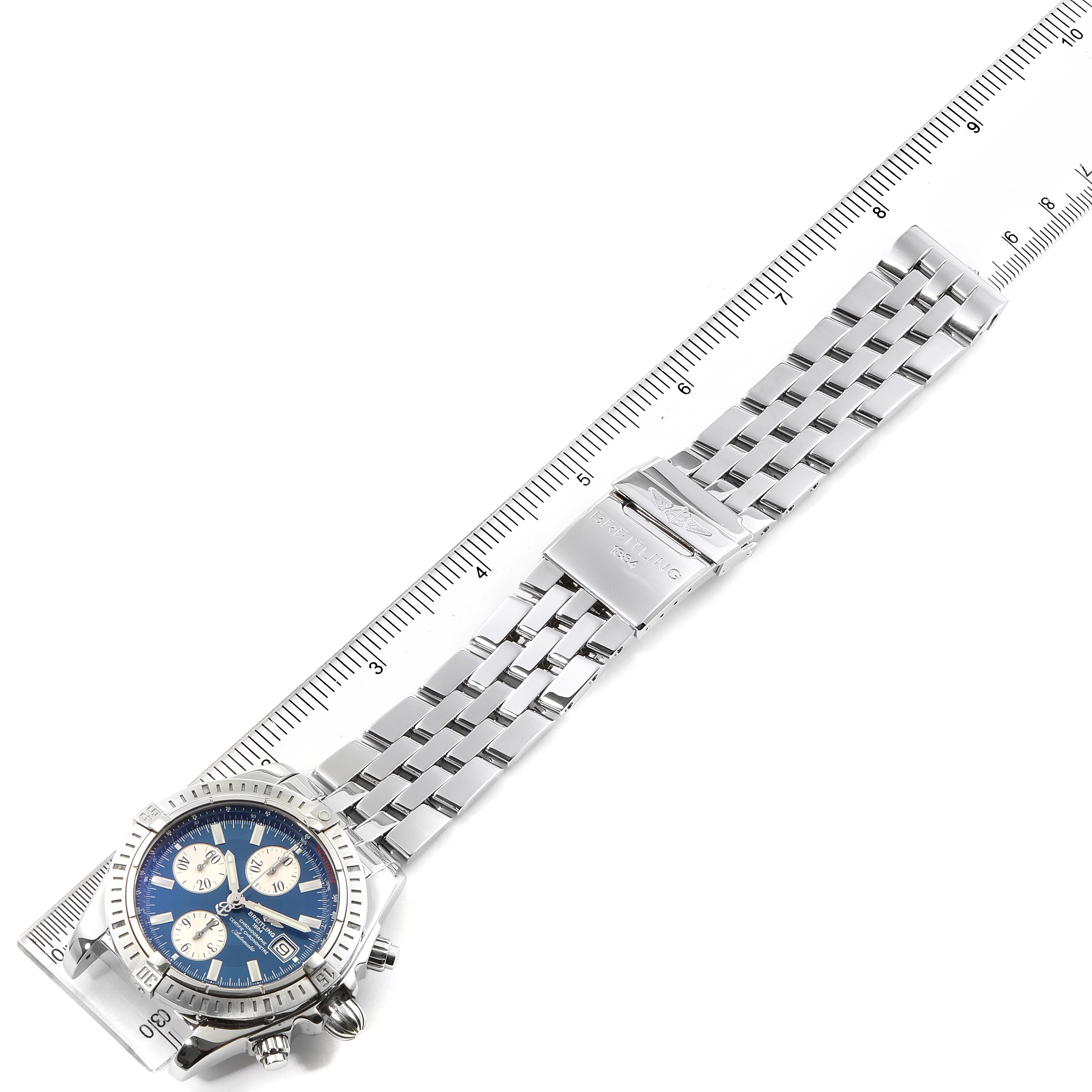 The image shows a laid flat Breitling Chronomat A13356 Men
s Stainless Steel Blue Dial A13356 Men
s Stainless Steel Blue Dial watch from the top, positioned alongside a ruler for scale.