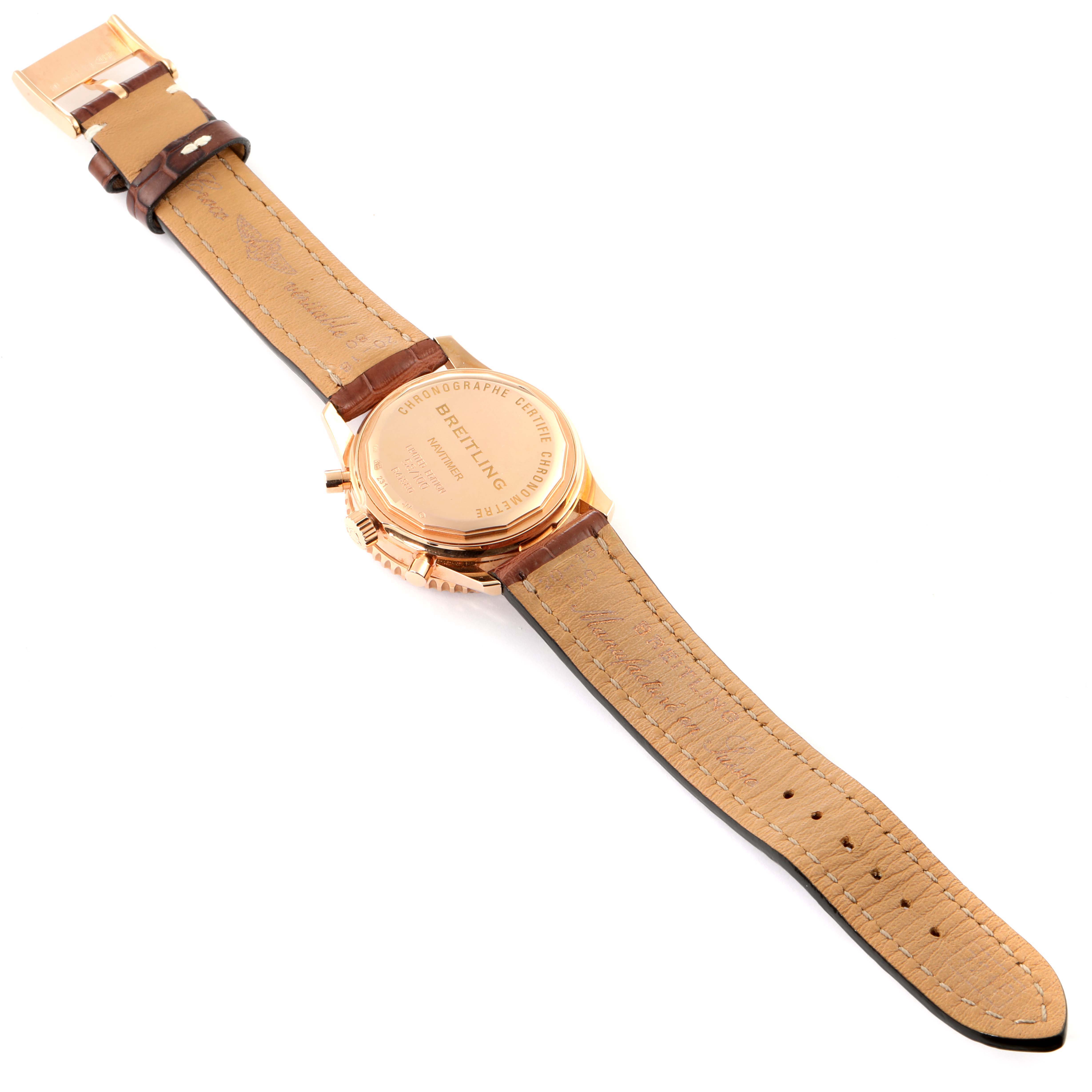 The image shows the back and strap of a Breitling Navitimer R41380 Men
s Rose Gold Silver Dial R41380 Men
s Rose Gold Silver Dial watch laid flat with the case back facing up.